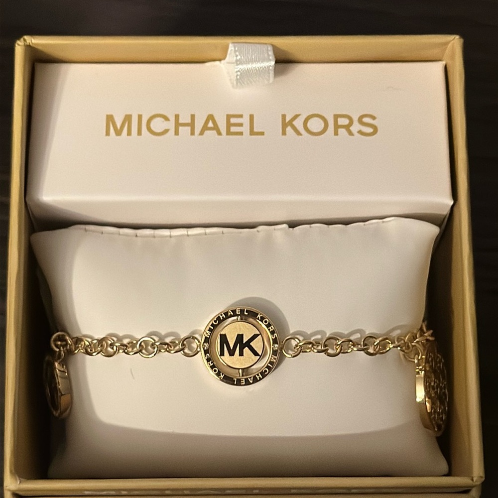 Michael Kors signature gold charm bracelet.
